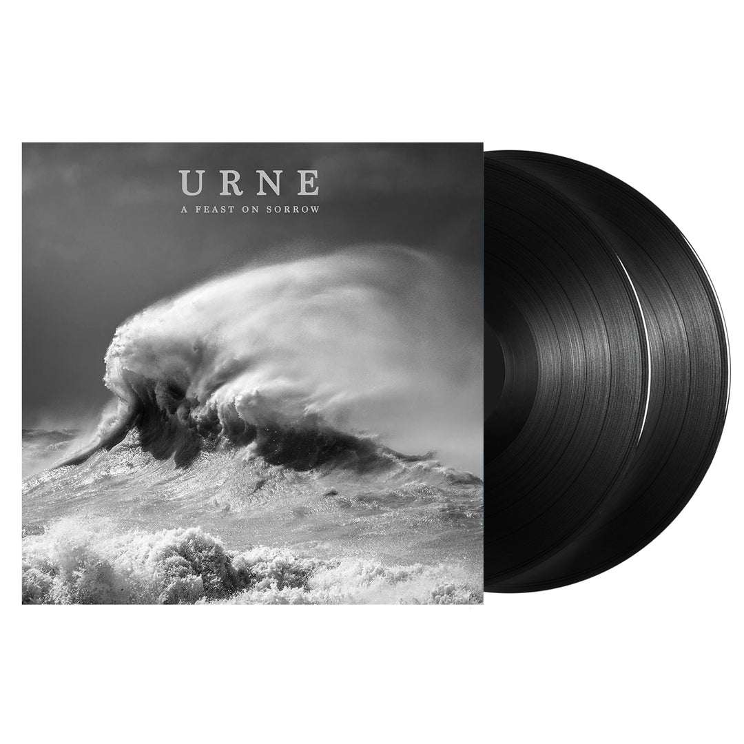 This image features the "A Feast On Sorrow - Black Vinyl 2xLP" by Urne. The album cover displays a monochrome photograph of a wave, capturing the essence of the album's title.