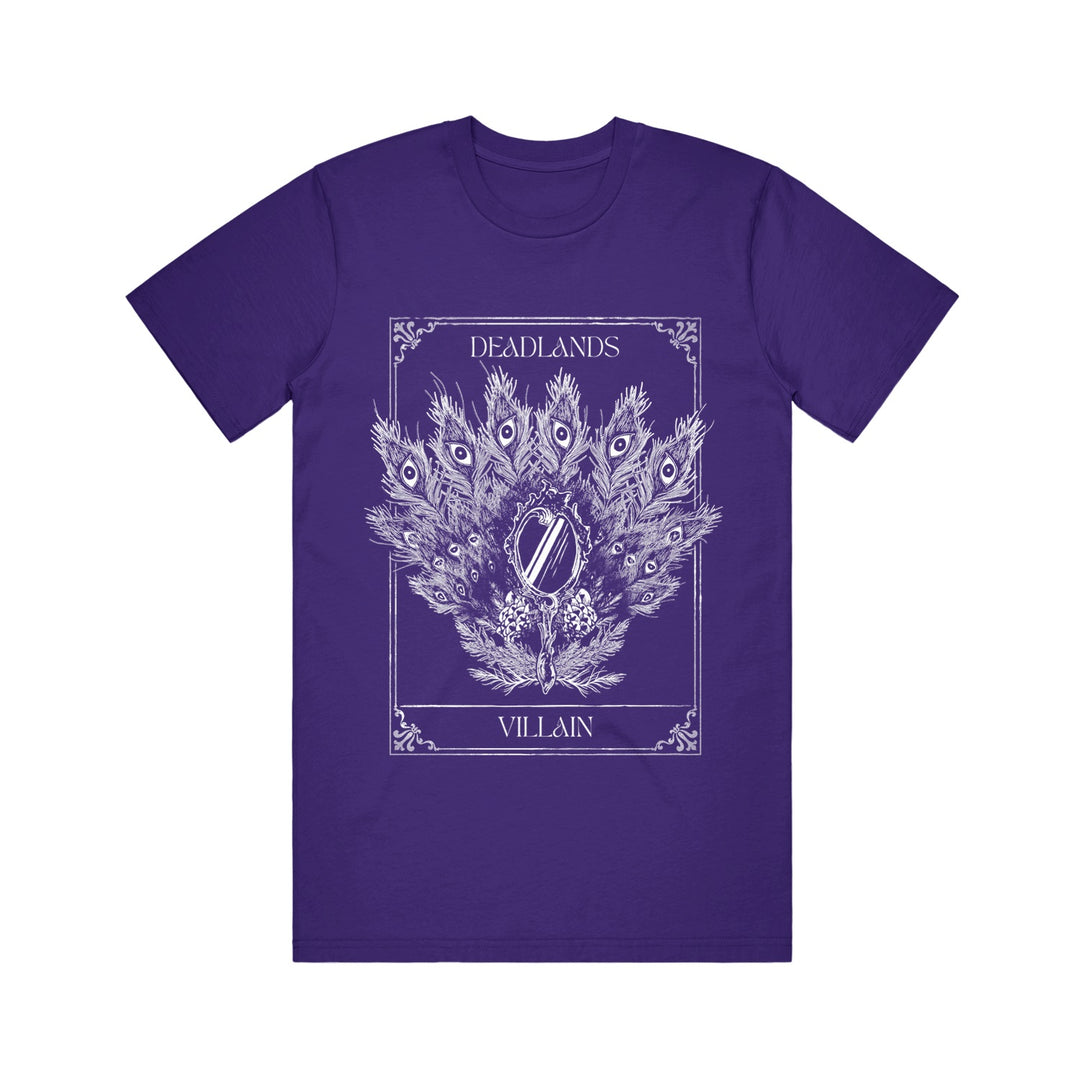 A purple Deadlands Heavy Cotton T-Shirt features a white line art of a peacock feather fan, pocket watch, and florals on 100% cotton, with DEADLANDS above and VILLAIN below in an ornate border.
