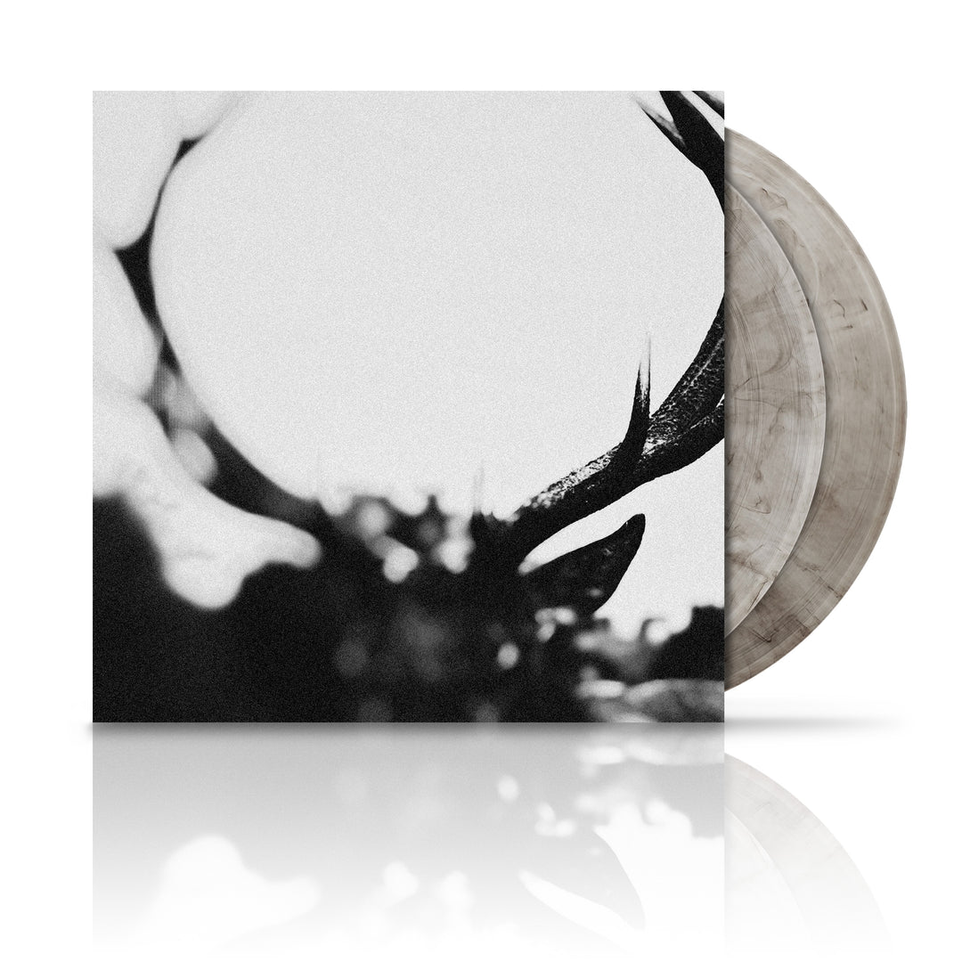 Black and white album cover art featuring a close-up of a deer's eye, with the vinyl LP visible in the background.