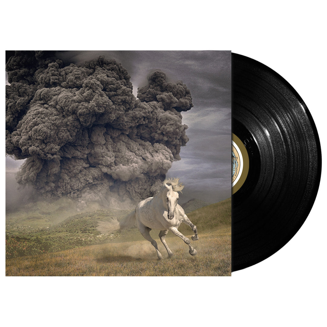 A vinyl record partially slides out of The White Buffalo album cover, showing a white horse running on grass with a dark cloud of smoke billowing in the cloudy sky—a dramatic scene inspired by “Life Goes On.”.
