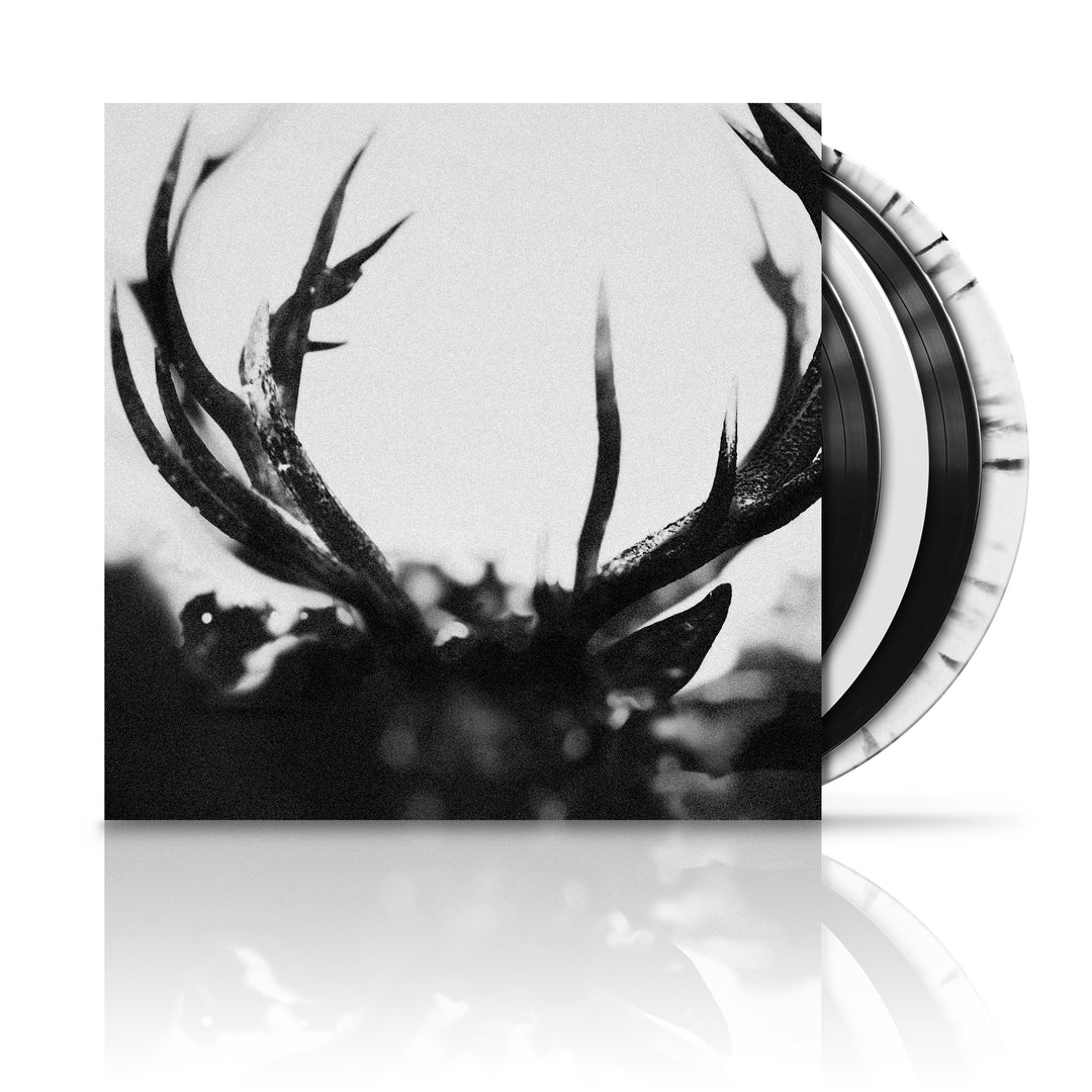 A black and white image of a LP record with deer antlers