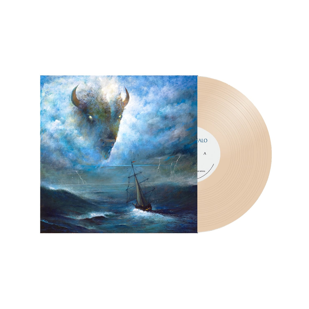 A beige vinyl record partially slides out from a Crown Lands album cover that shows a ship sailing stormy waves, with lightning and clouds in the sky forming the shape of a buffalo’s head.