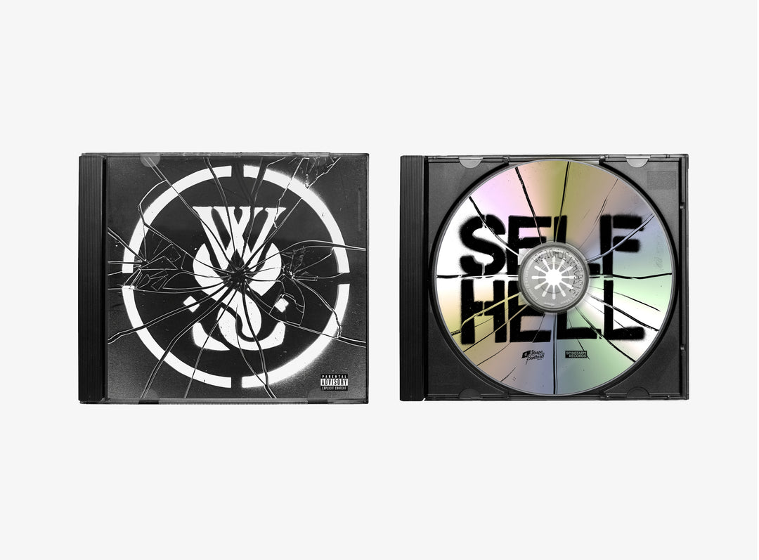 Two CD cases: the left shows a cracked black album cover with a white symbol; the right displays While She Sleeps 2024 SELF HELL CD, featuring bold black letters and visible cracks on the disc.