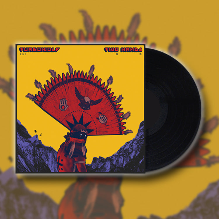 A vinyl record by Turbowolf slides out of its sleeve, which has bold artwork of a person in a feathered headdress holding a red fan with symbols, set on a yellow background with mountains.