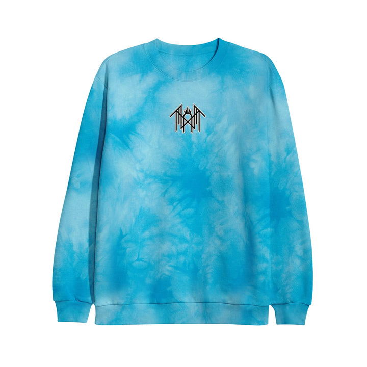 A blue tie-dye crewneck sweatshirt by Sleep Token, featuring a small black geometric rune-like logo printed on the center chest. The sweatshirt has long sleeves with ribbed cuffs and hem.