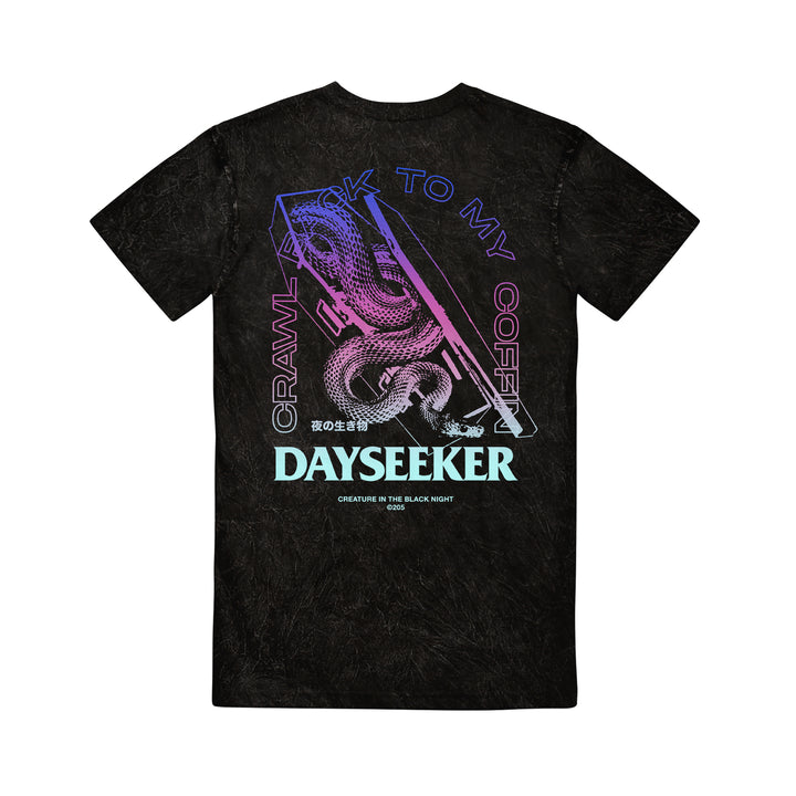 Black mineral wash t-shirt by Dayseeker featuring a neon snake wrapped around a coffin, with “CRAWL BACK TO MY COFFIN,” “DAYSEEKER,” Japanese characters, and “CREATURE IN THE BLACK NIGHT” printed below.
