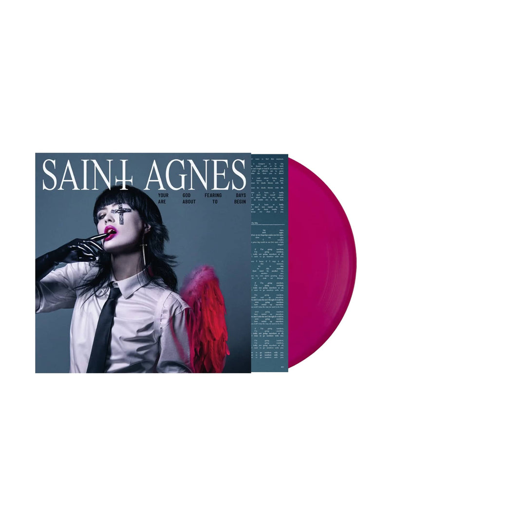 Saint Agnes Bloodsuckers album cover shows a person with pink angel wings, smudged makeup, shirt and tie, black-gloved hand by their mouth. The transparent magenta vinyl edition stands out in striking bright pink.