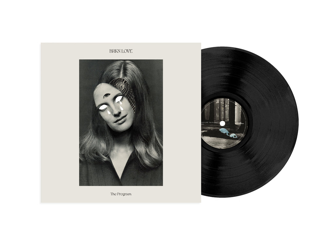 A Black Vinyl LP sits beside its album cover, which shows a vintage black-and-white photo of a woman with a surreal peeled mask revealing glowing eyes and digital patterns. BRKN Love: The Program is available now for presale before its album release.