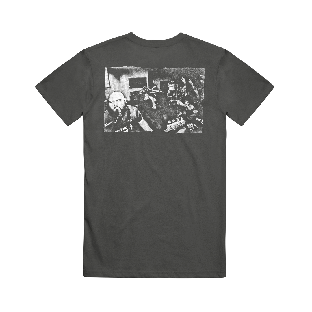A black Cold Steel printed t-shirt showcasing a grainy black-and-white photo of a band performing live before an energetic crowd, bringing dynamic energy and standout style to this tee.
