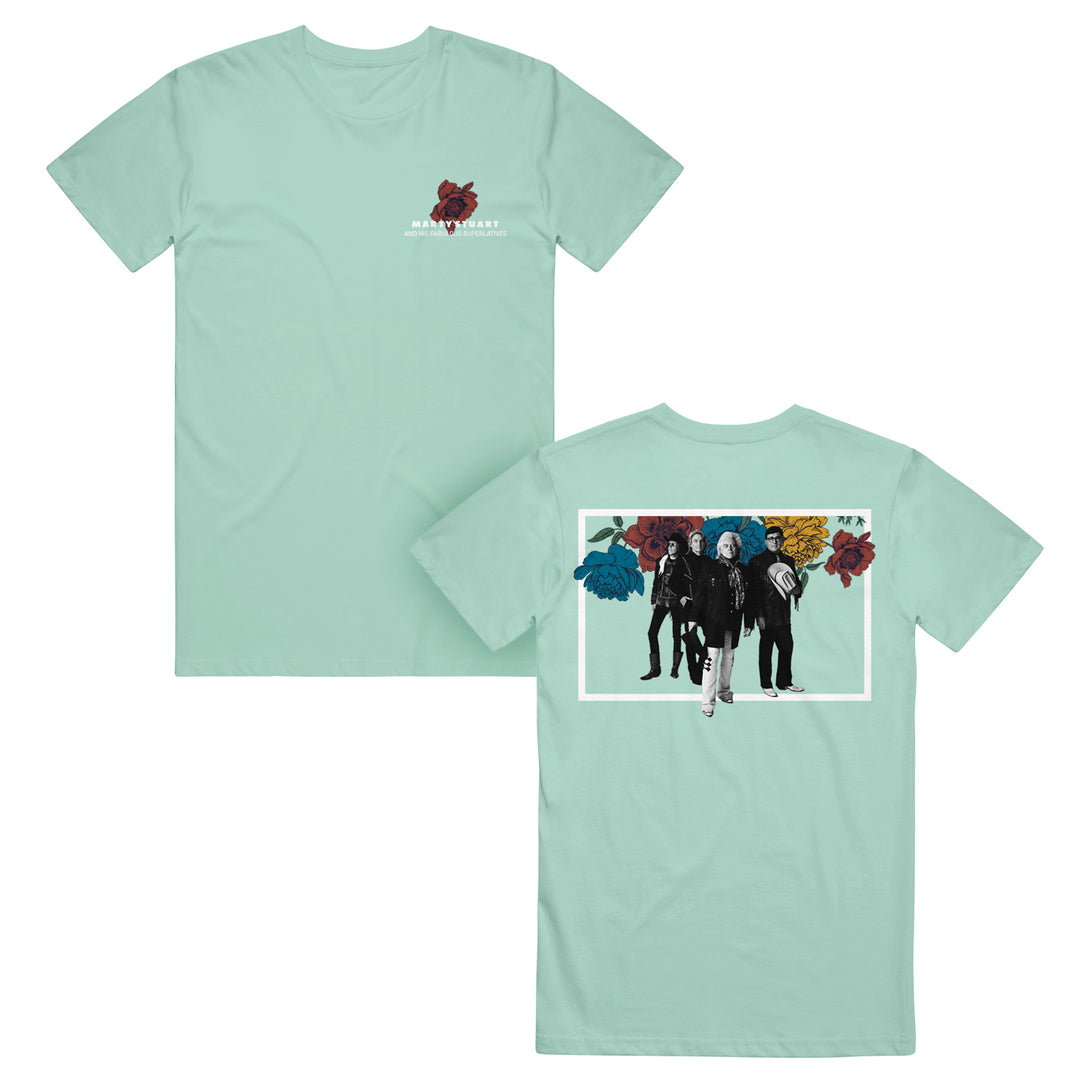 Front and back of a light blue Floral Mint T-shirt by Marty Stuart & His Fabulous Superlatives. Features a small Heart & Heart logo on the front and five people with colorful floral art above them on the back.