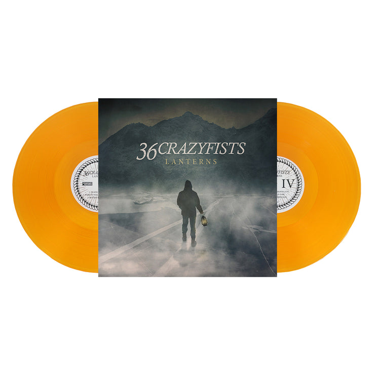 image of a gold vinyl record on a white background. image shows vinyl on each side. album cover in the center says 36 crazyfists lanterns. there is a man walking by water in front of mountains holding a lantern