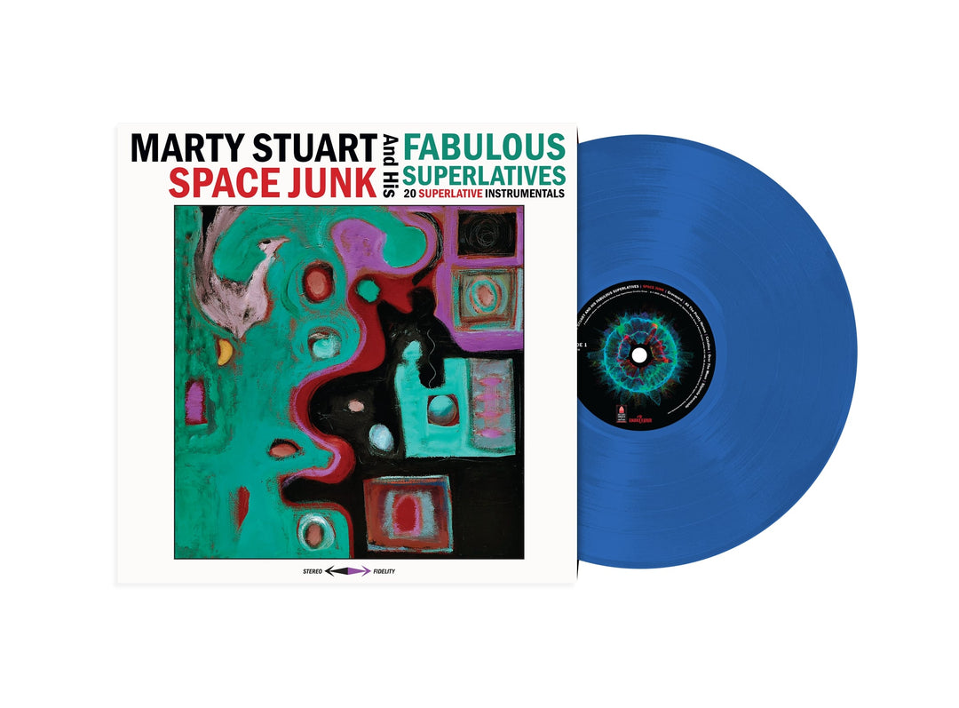 A blue Space Junk vinyl record partly pulled from its cover, which reads Marty Stuart & His Fabulous Superlatives: Space Junk - 20 Superlative Instrumentals, a limited edition double LP with colorful abstract artwork on the front.
