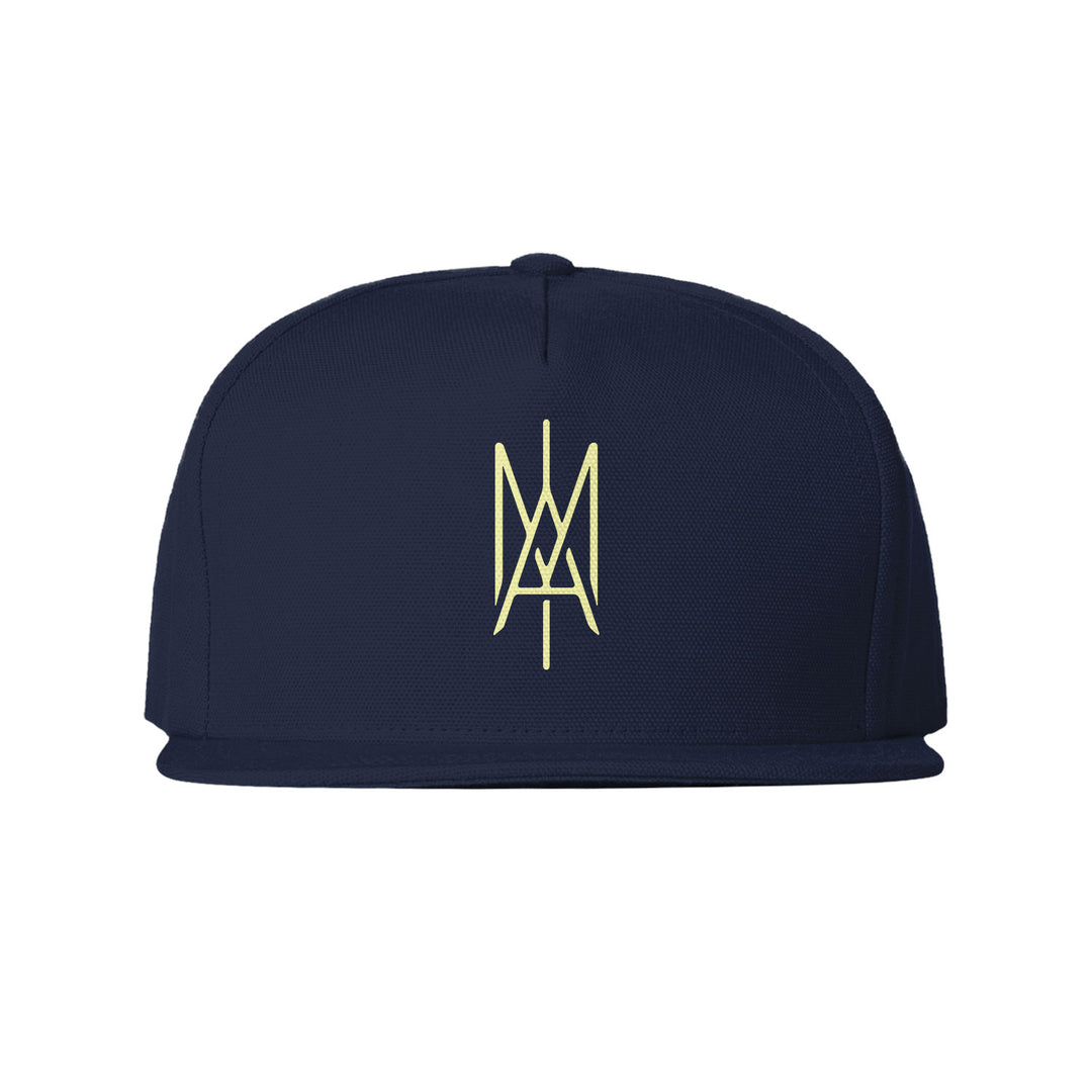 A navy blue Toothgrinder flat-brim cap featuring a yellow geometric monogram on the front panel.
