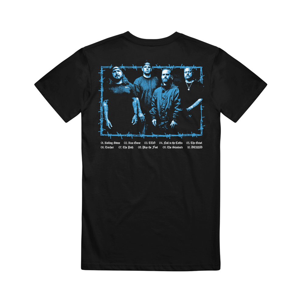 The Southpaw FLHC Photo Black T-shirt features a blue-tinted image of four men standing together on the back, framed in barbed wire, with white song titles listed below.
