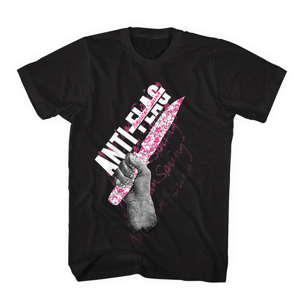 image of a black tee shirt on a white background. tee has full body print that says anti flag and has a hand holding a knife