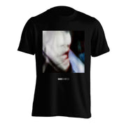image of the front of a black tee shirt on a white background. tee  has point oblivion cover of a blurred face