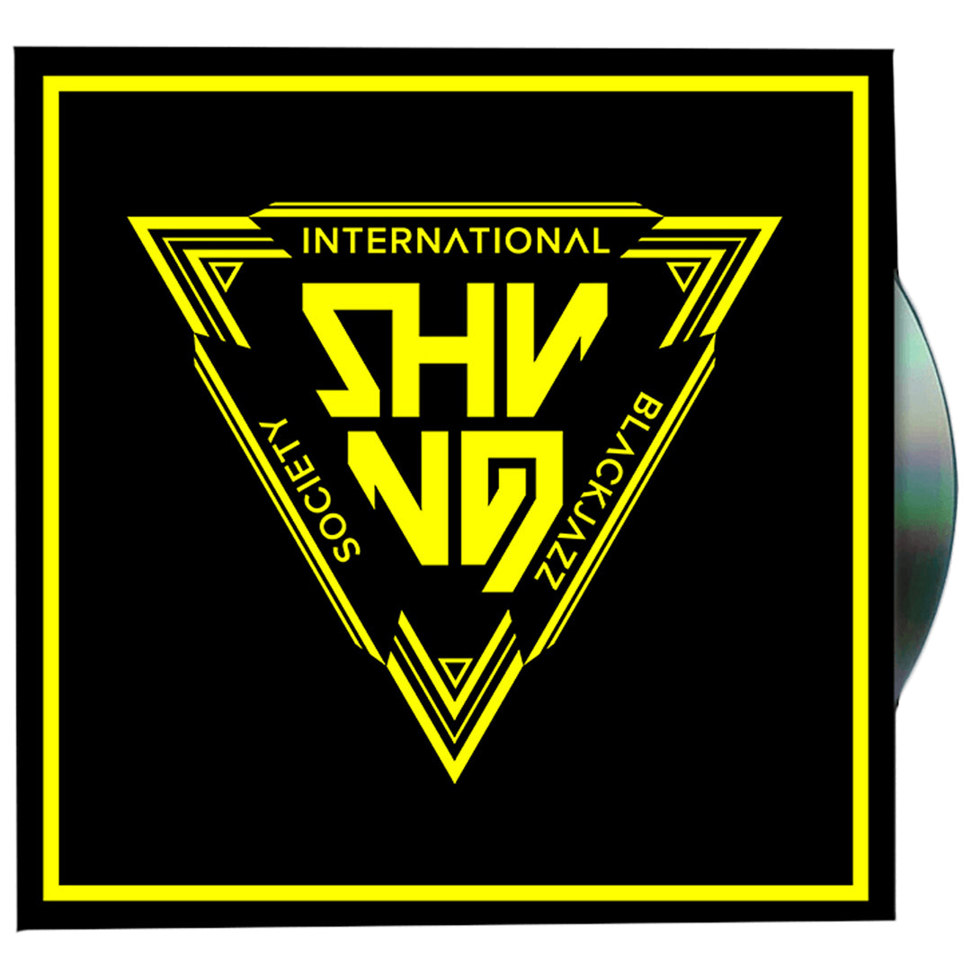 A black square album cover from Shining featuring a yellow triangular logo with the words SHYNO, INTERNATIONAL, BLACKJAZZ, and SOCIETY; a CD edge appears on the right.