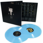 image for the IMPORT Self Titled Deluxe Edition Baby Blue Vinyl LP. two records on the bottom, cover on the top is a black and white skull