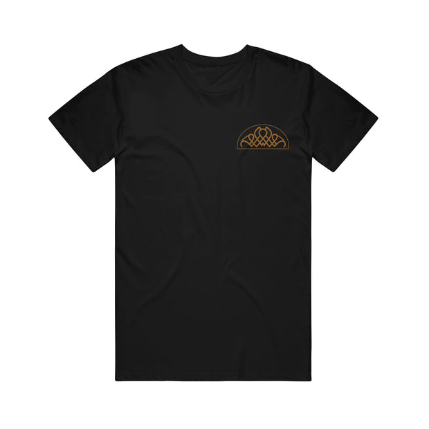 image of the front of a black tee shirt on a white background. tee has  has a small gold right chest print of a geometric design